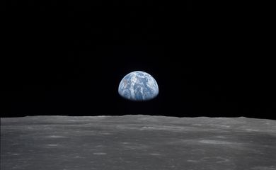 View of Moon limb with Earth on the horizon,Mare Smythii Region. Earth rise. This image was taken before separation of the LM and the Command Module during Apollo 11 Mission. Original film magazine was labeled V. Film Type: S0-368 Color taken with a 250mm lens.  Approximate photo scale 1:1,300,000. Principal Point Latitude was 3 North by Longitude 85 East. Foward overlap is 90%. Sun angle is High. Approximate Tilt minimum is 65 degrees,maximum is 69. Tilt direction is West (W).