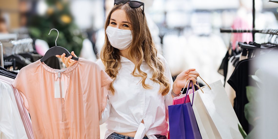 Woman shopping protecting herself wearing protective mask.