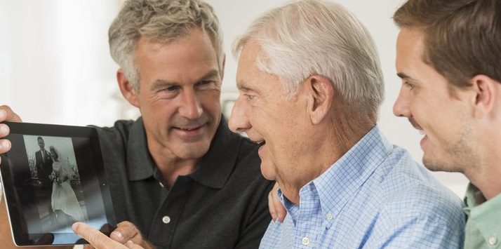 Three generations of Caucasian men using digital tablet