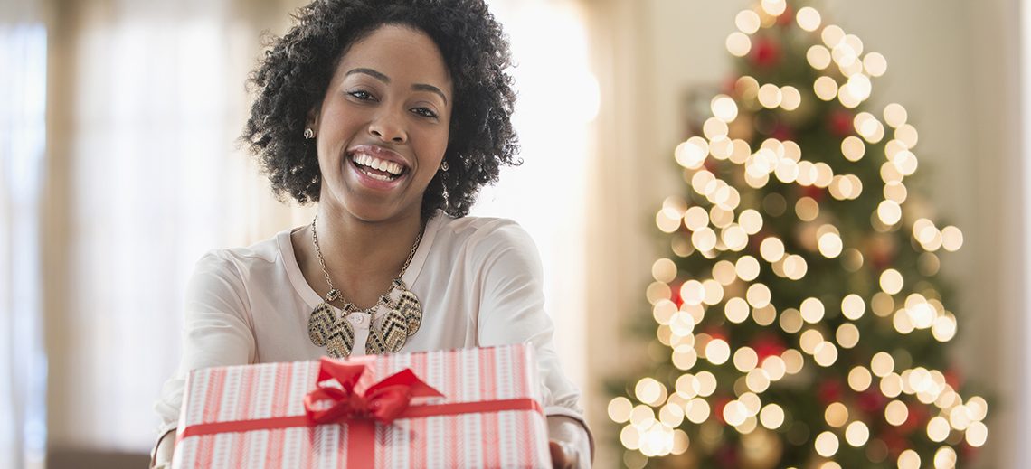 Mixed race woman holding Christmas gift