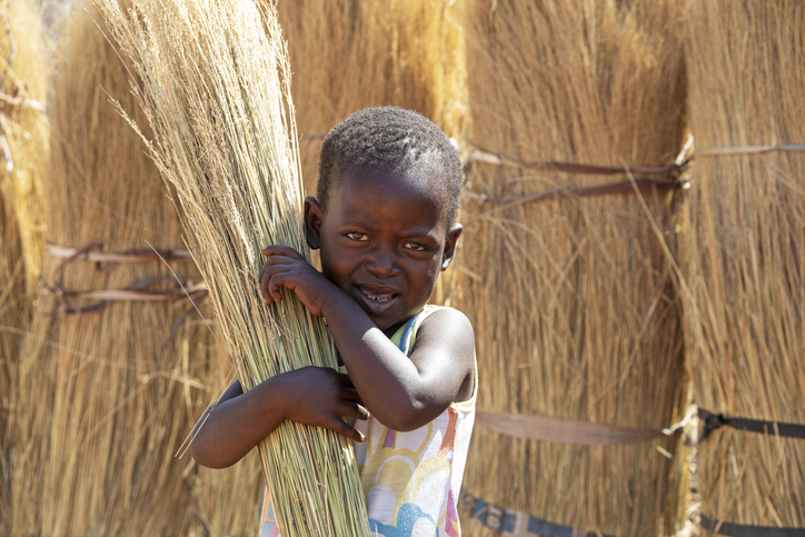African girl African girl child labor, in a  village in Botswana holding a broom