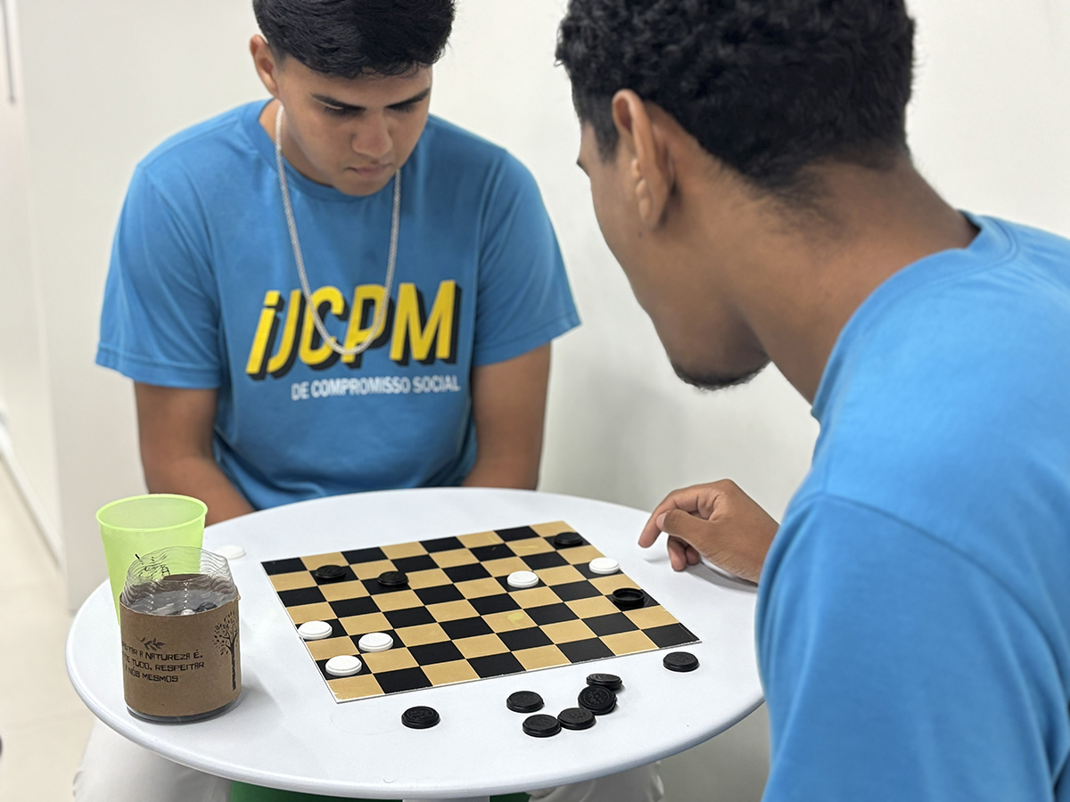 No intervalo_os jovens trocam as telas pelo jogo de dama
