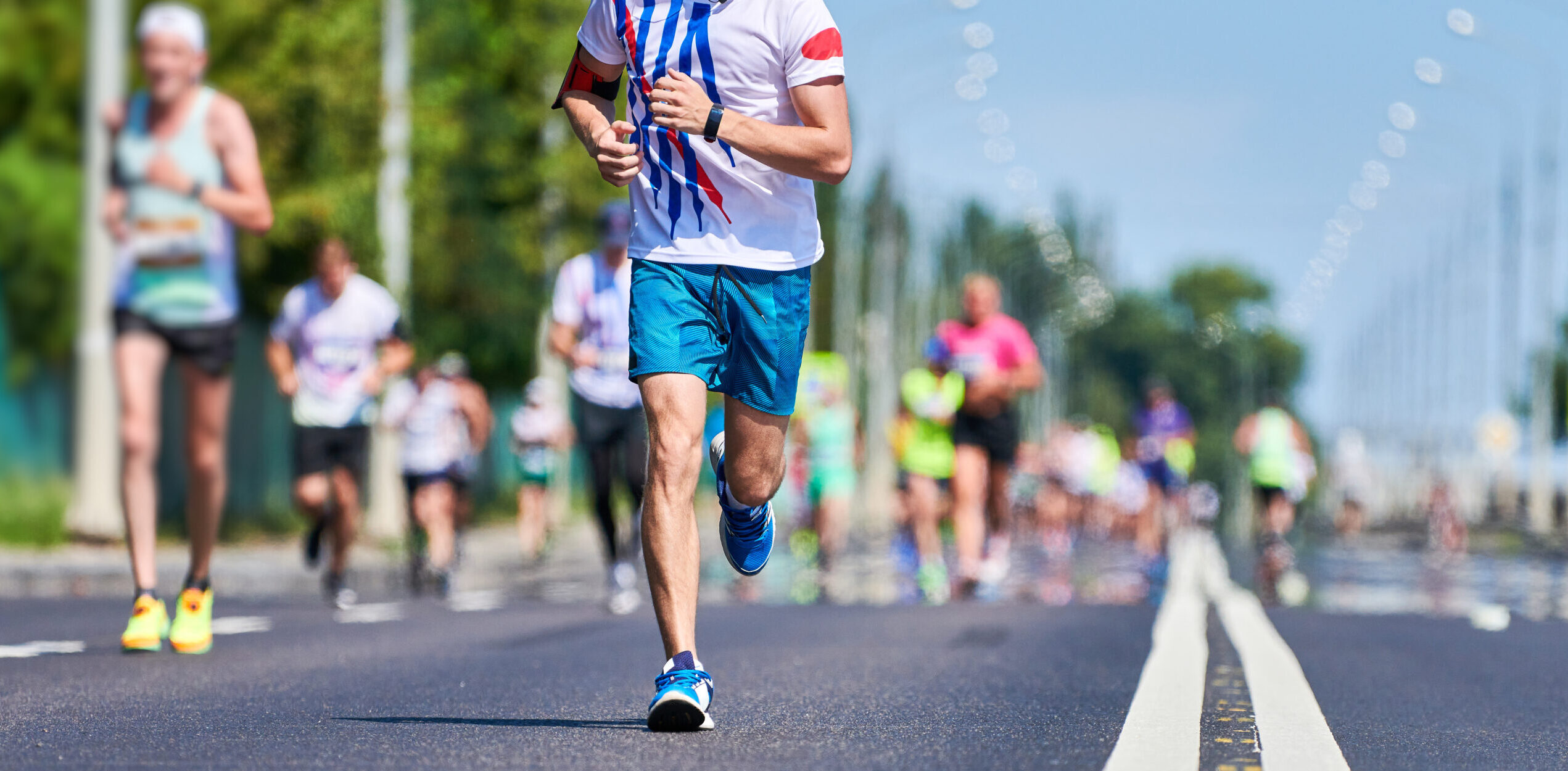 Marathon runners on city road. Running competition. Street sprinting outdoor. Healthy lifestyle, fitness sport event.